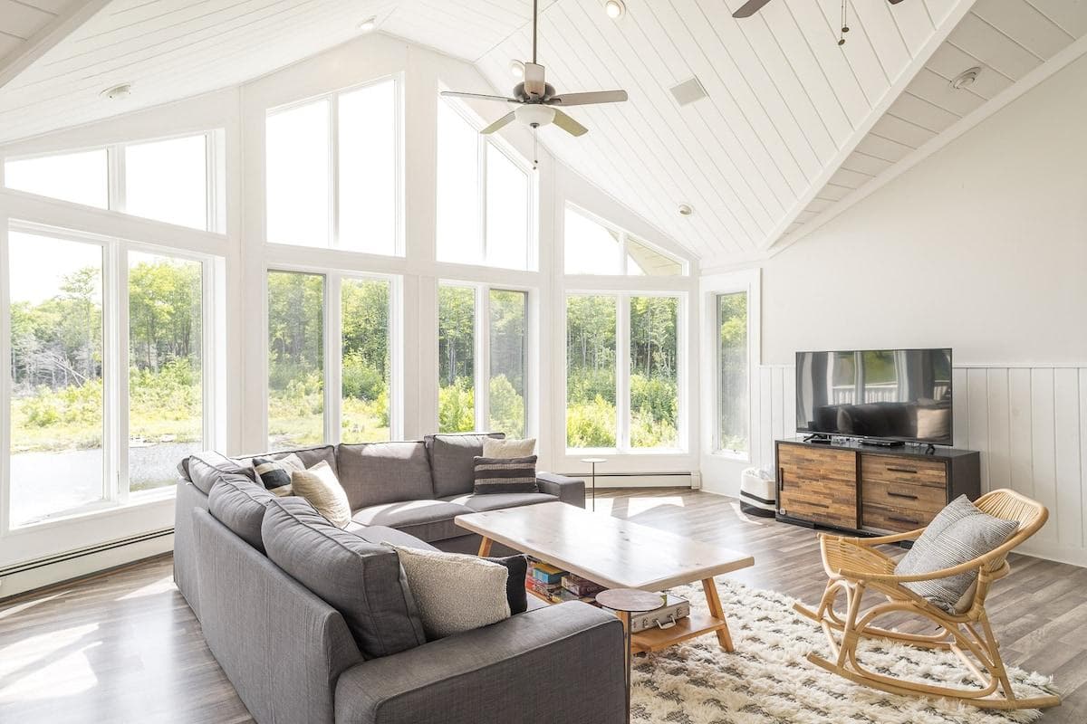Relax in the sunny 2nd floor living room with vaulted ceiling,  a large smart TV and pond views. Perfect for game night!
