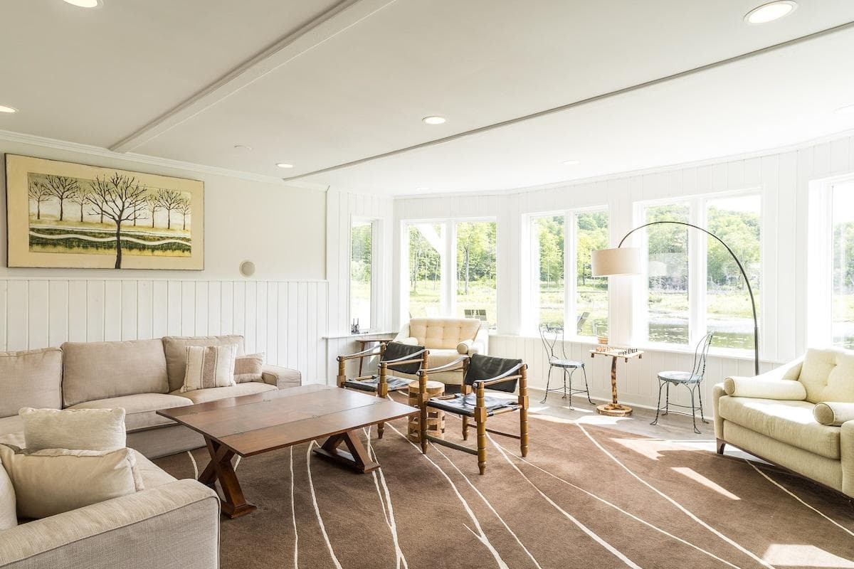 Bright, spacious 1st floor living room with cozy seating and a large TV.